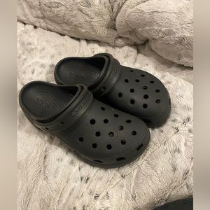Black crocs, worn